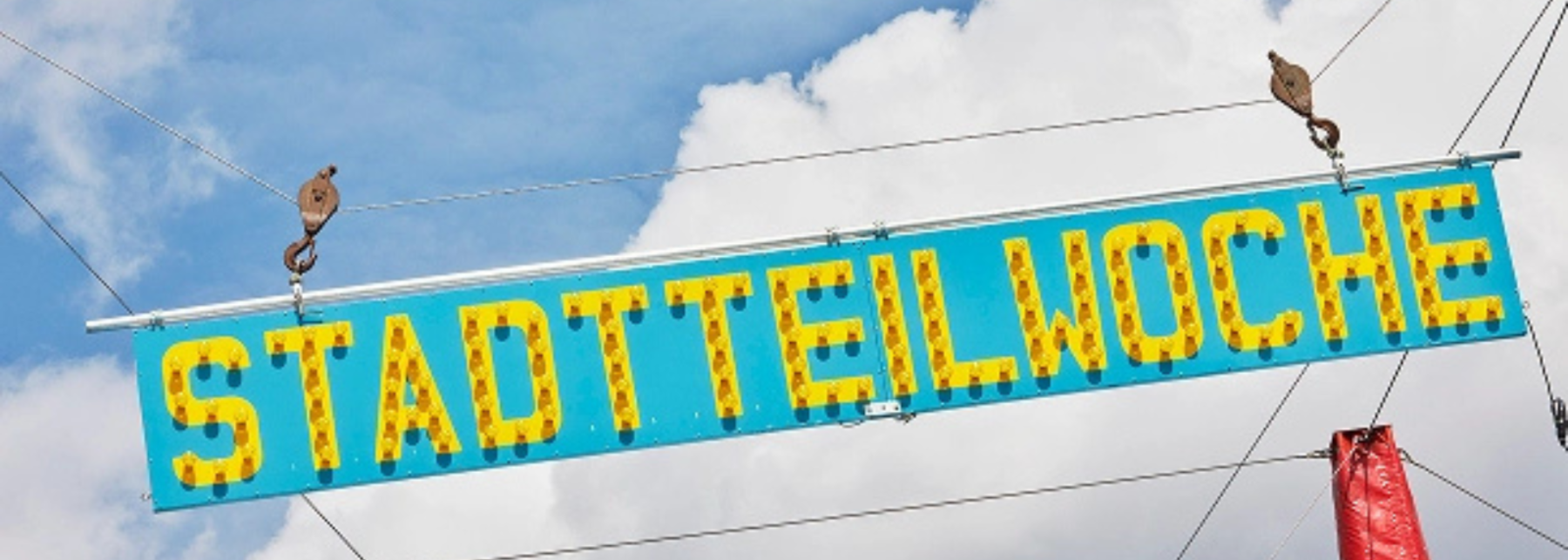 Schild mit Aufschrift "Stadtteilwoche"